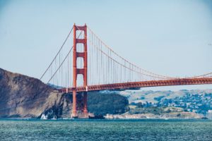 Picture of Golden Gate Bridge over the Bay with mountain in background